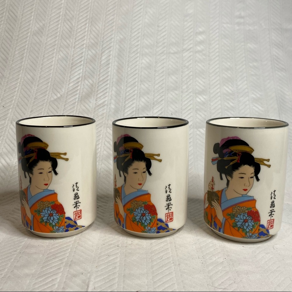 Three Asian tea cups with geisha girl.